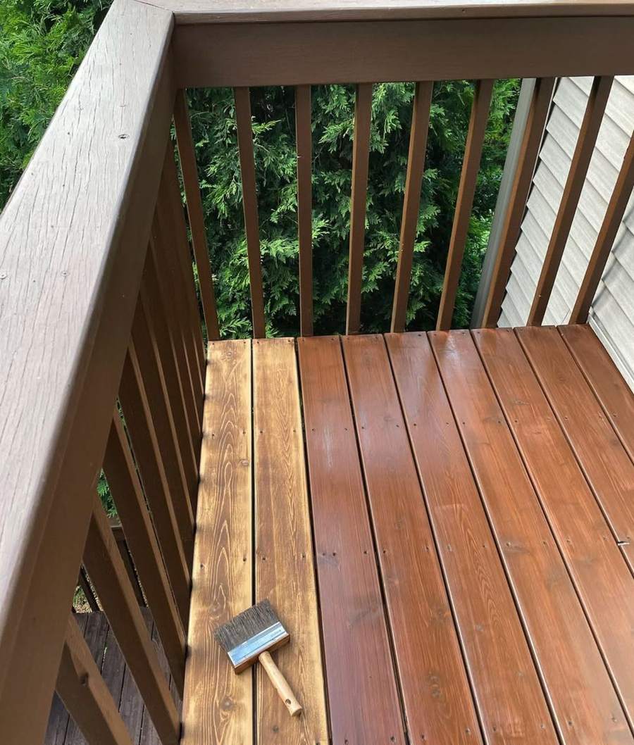 A balcony floor with stained boards beside boards not yet stained