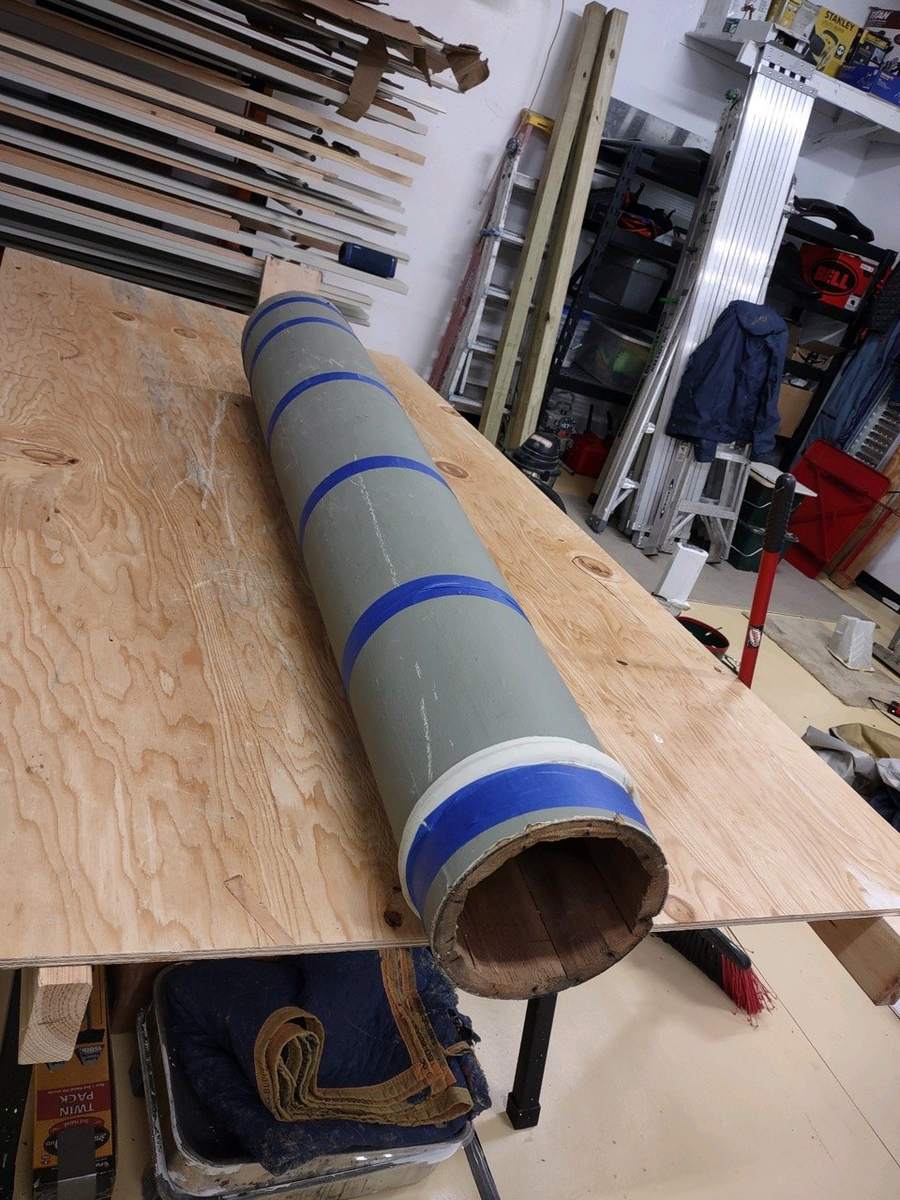 The column taped and clamped back together on the bench