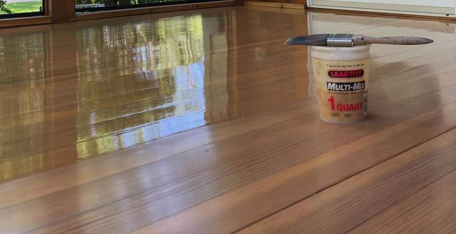 A glossy, freshly varnished wood porch floor