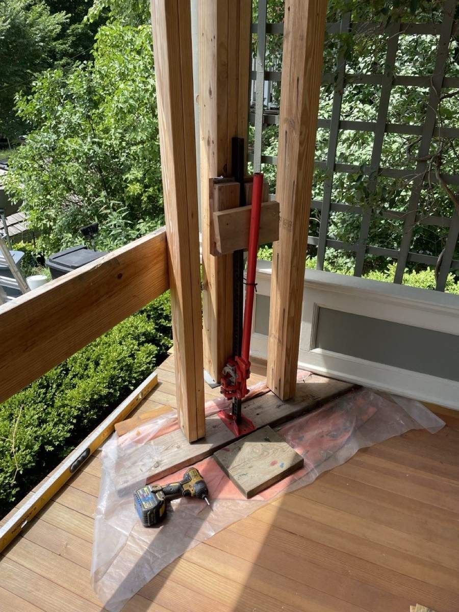 A jack between temporary posts on the porch