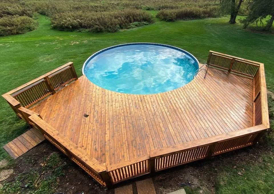 The same pool deck after refinishing, in a warm cedar tone