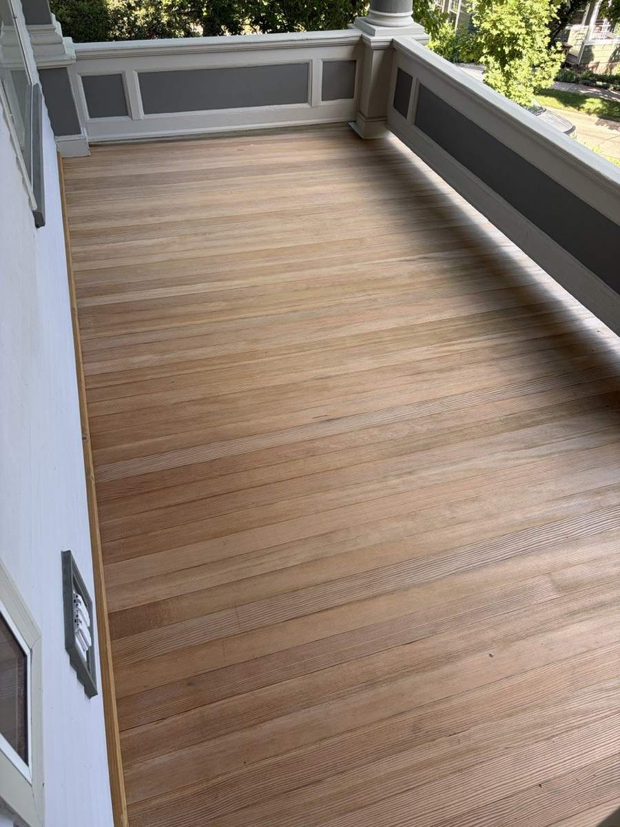 The porch floor stripped to bare wood
