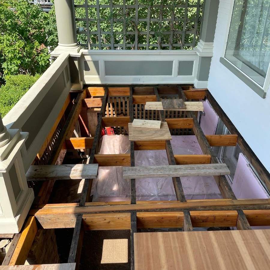 A porch stripped down to its floor joists