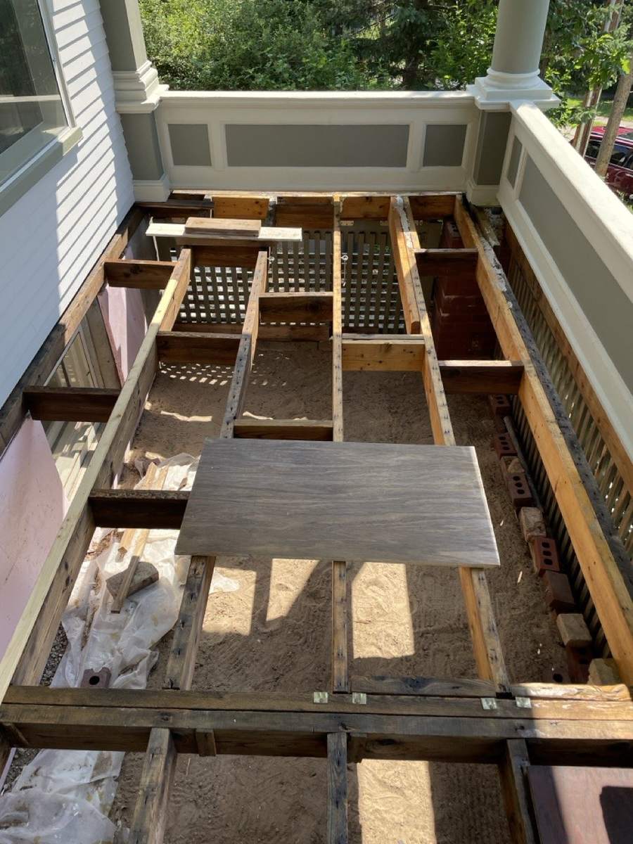 The porch stripped down to its joists