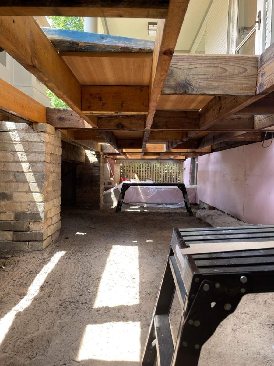 The space under the porch, looking along the framing