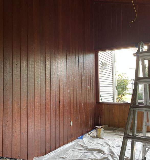 Stained vertical board walls inside a screened porch