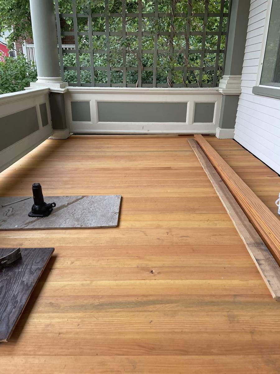 The whole porch floor laid in bare wood